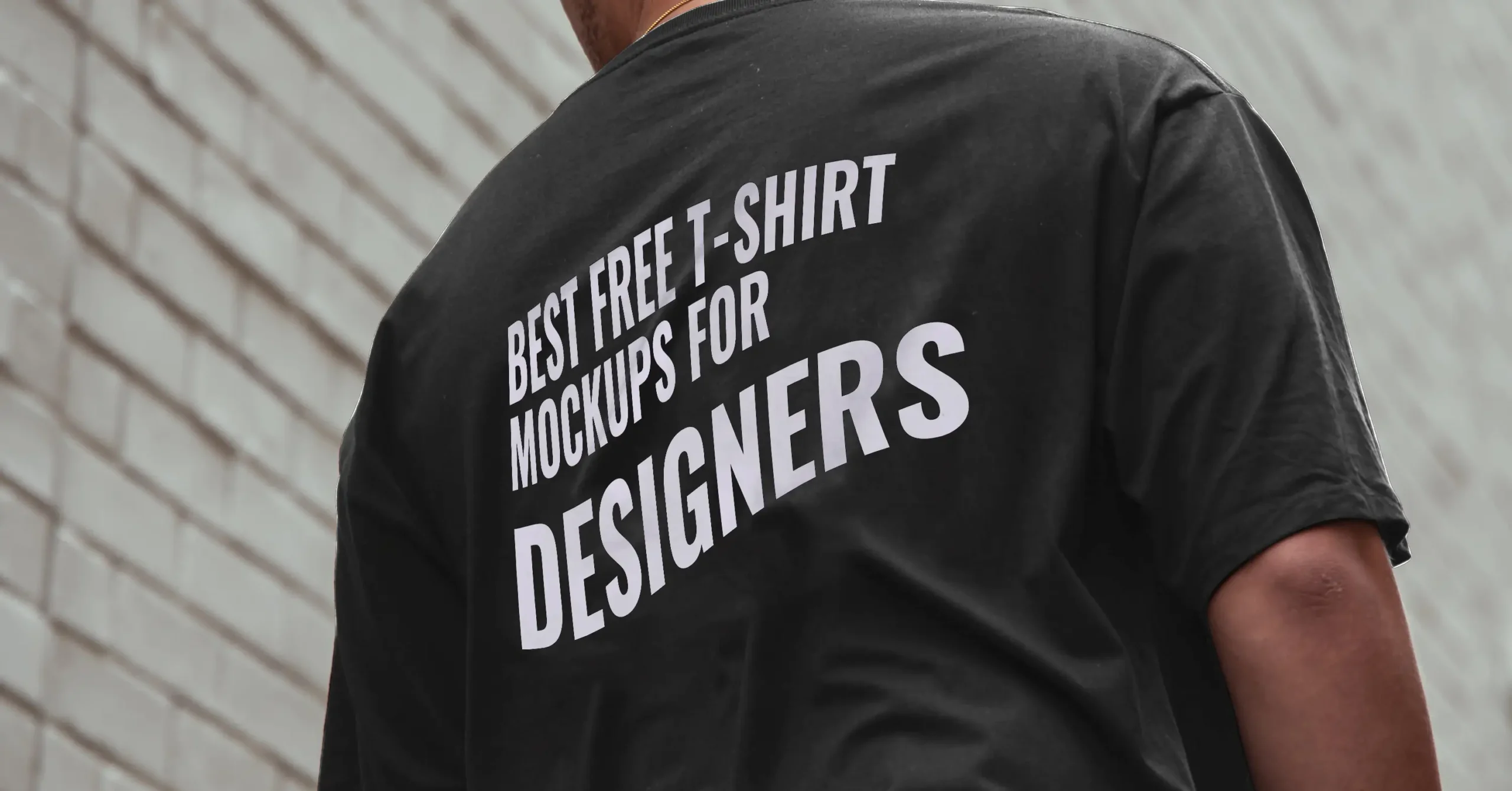 Black t-shirt with white text promoting Free T-Shirt Mockups for Designers.
