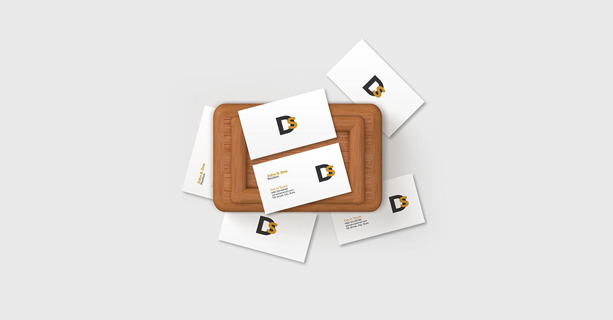 scattered business cards mockup with minimalist white cards arranged on wooden tray and textured surface
